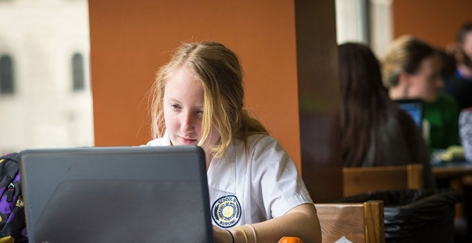 nursing student working on a laptop